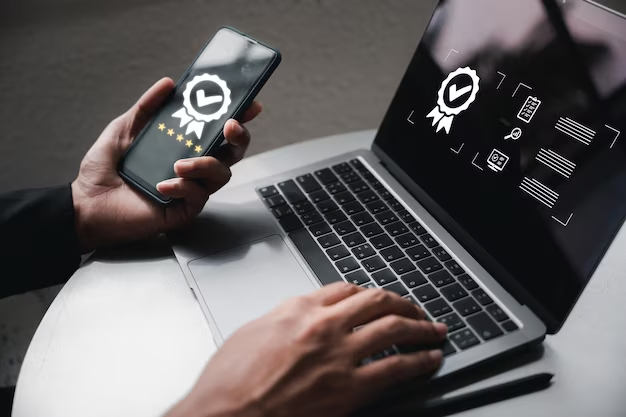 Man working on a laptop with a phone